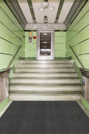 Millburn apartment for rent - A staircase with a black carpeted floor and green walls.