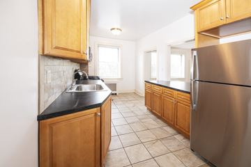 Millburn apartment for rent - A kitchen with wooden cabinets and a stainless steel refrigerator.
