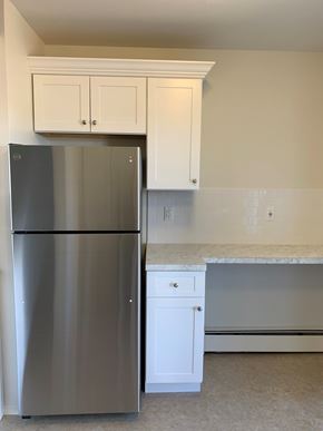 Atlantic Highlands apartment for rent - A stainless steel refrigerator in a kitchen with white cabinets.