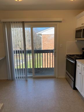 Atlantic Highlands apartment for rent - A kitchen with a black oven and white cabinets.