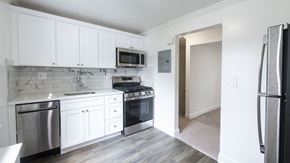 New Milford apartment for rent - A kitchen with white cabinets and stainless steel appliances.