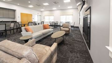 New Milford apartment for rent - A living room with a grey carpet and a white couch.