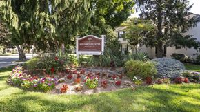 New Milford apartment for rent - A sign for Millford Estates is in front of a flower bed.