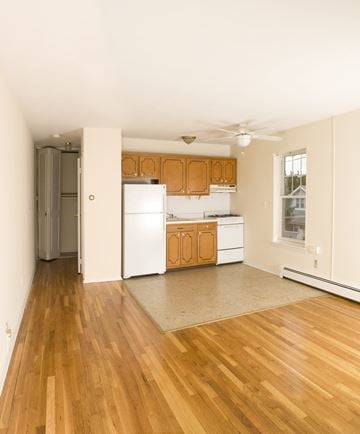 Ridgefield Park apartment for rent - A kitchen with wooden floors and white appliances.