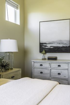 Salinas apartment for rent - A bedroom with a bed, nightstand, and a large picture on the wall.