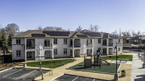 Salinas apartment for rent - A large white building with a playground in front.