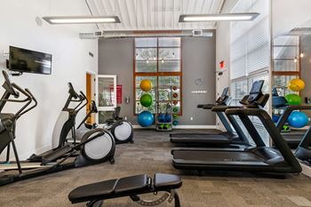 A gym with treadmills and other exercise equipment