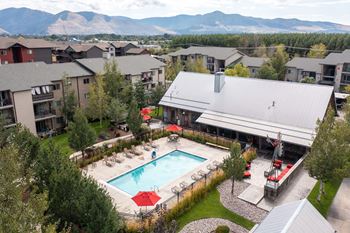 An aerial view of the resort style pool with lounge chairs and umbrellas