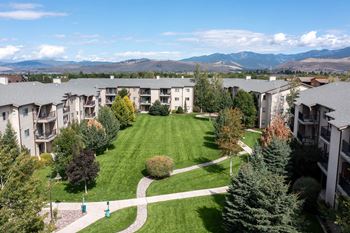 An aerial view of an apartment complex with a lawn