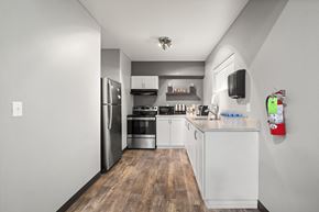Auburn apartment for rent - a kitchen with white cabinetry and stainless steel appliances at Mill Pond Apartments, Auburn, WA 98092
