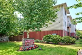 Salem apartment for rent - Property entrance sign with seasonal flowers and landscaping at Monroe Avenue Apartments, Salem, 97301