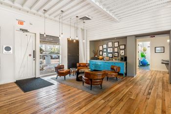 A living room with wood floors and a blue bar