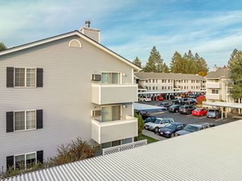 A modern house with a parking lot in front.