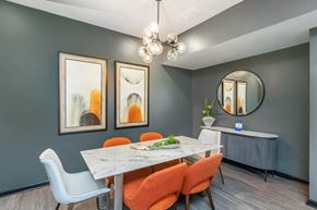 Marietta apartment for rent - A dining room with a white table and orange chairs at Crest at East Cobb Apartments, Marietta, Georgia