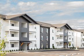 East Wenatchee apartment for rent - a row of white and gray apartment buildings with a parking lot at Gateway Apartments, Washington, 98802