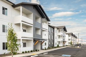 East Wenatchee apartment for rent - a row of white apartments with balconies and a street at Gateway Apartments, Washington
