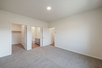 East Wenatchee apartment for rent - a living room with white walls and carpet and a door to a bathroom