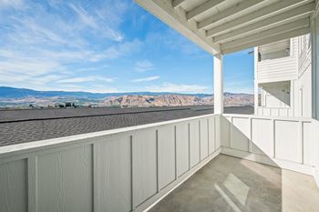 The view from the balcony of a house overlooking the mountains