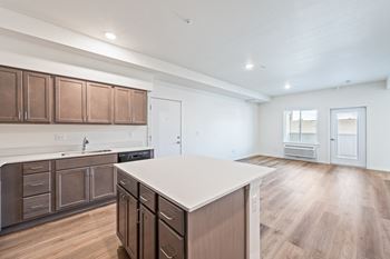 An open kitchen with a white counter top in a new home