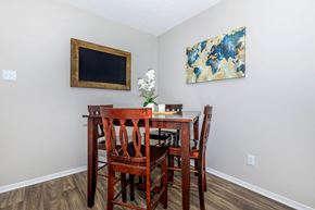 Huntsville apartment for rent - a dining room table with chairs and a painting on the wall at The Davis Apartments, Huntsville, AL 35816  