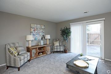 Winston-Salem apartment for rent - A living room with a grey carpet and furniture.