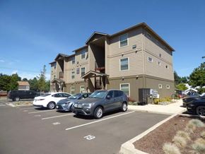 Salem apartment for rent - Exterior view of modern apartment building with parking area at Waln Creek Apartments, Salem