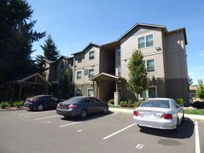 Salem apartment for rent - Parking lot with covered entry and modern three story building at Waln Creek Apartments, Salem, OR