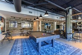 Tacoma apartment for rent - a pool table sits in the middle of a room with a bar in the background at Napoleon Apartments, Tacoma, 98402