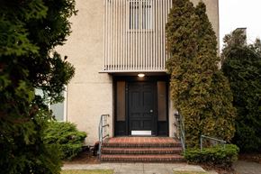Seattle apartment for rent - A house with a black door and a small porch.