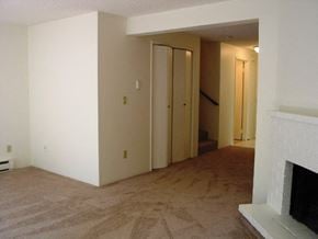 Bellevue townhouse for rent - an empty living room with a fireplace