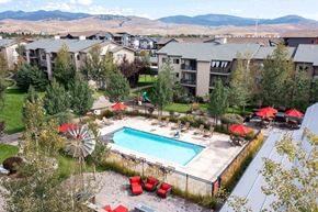 Missoula apartment for rent - Aerial view of a pool with lounge chairs and umbrellas  at Mullan Reserve Apartments, Missoula, MT, 59808