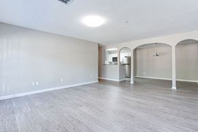 Stockbridge apartment for rent - A spacious room with light grey flooring and white walls at Ballantyne Commons of Stockbridge Apartments, Stockbridge, GA, 30281