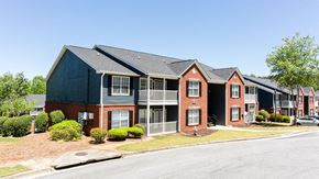 Stockbridge apartment for rent - A row of townhouses with a clear blue sky above at Ballantyne Commons of Stockbridge Apartments, Georgia