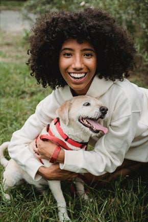 Bellevue townhouse for rent - a woman sitting in the grass holding a dog