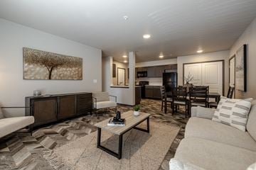 Cashmere apartment for rent - A living room with a sofa, coffee table, and a painting on the wall.