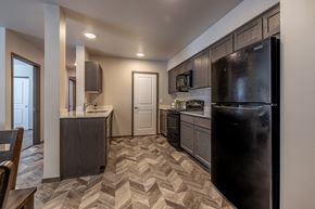 Cashmere apartment for rent - a kitchen with dark wood cabinets and a chevron floor