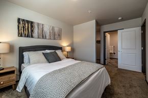 Cashmere apartment for rent - a bedroom with a large bed and a door to a bathroom