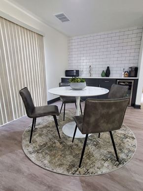 Lithonia apartment for rent - A dining room with a white table and chairs at Chelsea Place Apartments, Lithonia