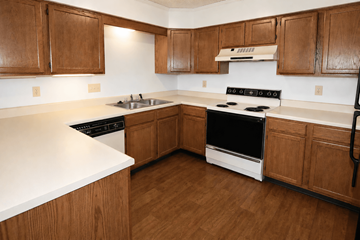 Kansas City townhouse for rent - A kitchen with wooden cabinets and a white counter top.