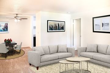Shawnee apartment for rent - A living room with a grey couch, a coffee table, and a painting on the wall.