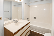 Kansas City townhouse for rent - A white sink with a wooden counter top and a white toilet in a bathroom.