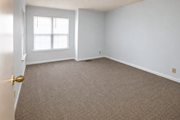 Kansas City townhouse for rent - A room with a carpeted floor and a window with blinds.