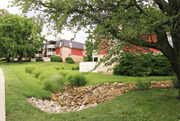 Mission apartment for rent - A red building with a stone wall in front of it.
