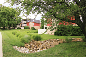 Mission apartment for rent - A red building with a stone wall in front of it.
