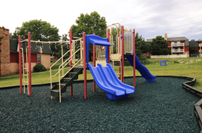 Mission apartment for rent - A playground with a blue slide and a yellow and red structure.
