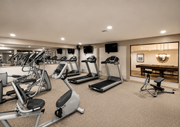 Overland Park townhouse for rent - A well-lit gym with a variety of exercise equipment.