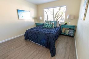 Dixon apartment for rent - A bedroom with a bed, nightstand, and lamp.
