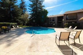 Dixon apartment for rent - A pool surrounded by chairs and trees.
