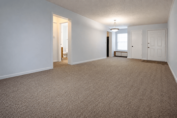 Kansas City townhouse for rent - A room with a carpeted floor and a light hanging from the ceiling.