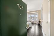 San Francisco townhouse for rent - a green door leading into a bedroom with a bed and a window